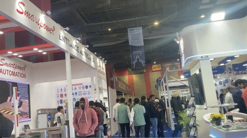 A busy exhibition floor at IFSEC India 2025 showcasing various security technology booths and attendees engaging with exhibits.